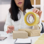 Transparent packing tape roll, high adhesive, for secure sealing.