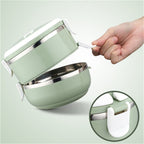 Two-layer insulated stainless steel lunch box, shown closed with an arched handle.