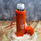 Elegant stainless steel reusable water bottle on a natural wooden surface.