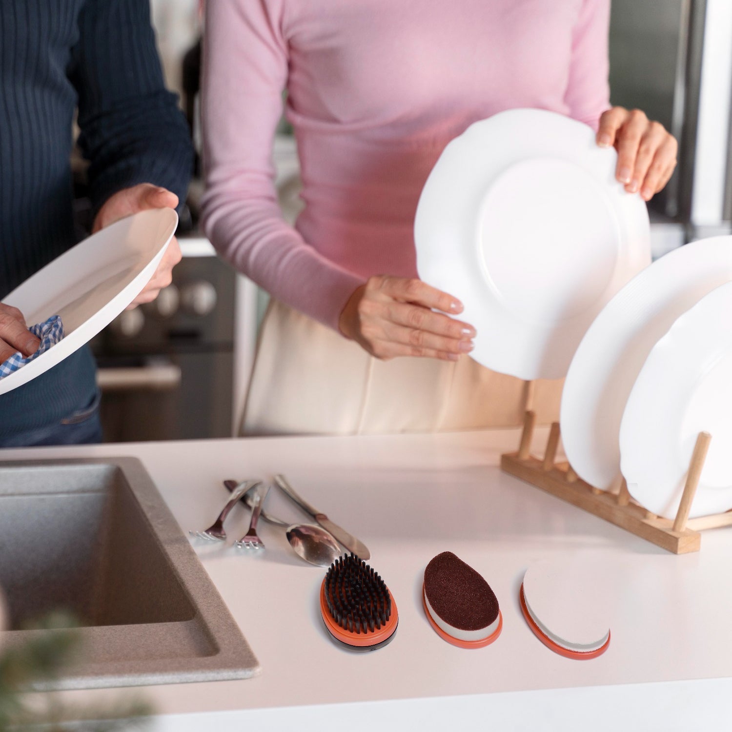 Ergonomic wet and dry brush vigorously cleaning a kitchen counter surface.