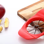 Ganesh Apple Cutter in action, showing perfect slices of a red apple.