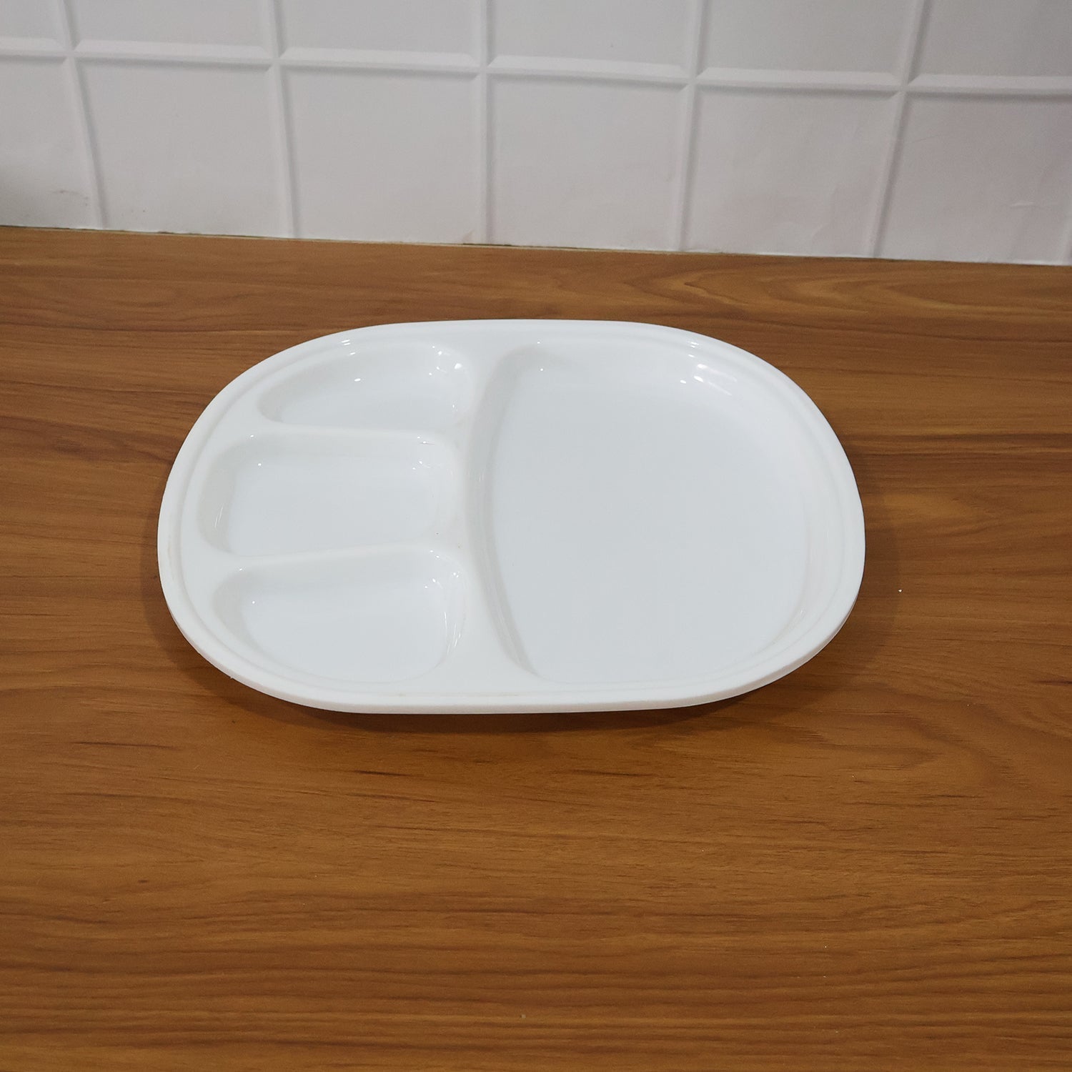 Plastic compartment plate in use with Indian meal served in sections