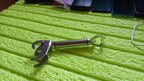 Close-up of the hot bowl holder's handle, revealing its convenient integrated bottle opener.