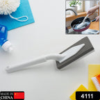 Versatile triangle cleaning brush effectively scrubbing a kitchen sink.
