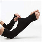 Athlete cycling outdoors wearing black sports arm sleeves, demonstrating active use.