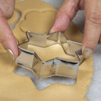 Close-up shot of the collection of stainless steel cookie cutters showing their varied sizes.
