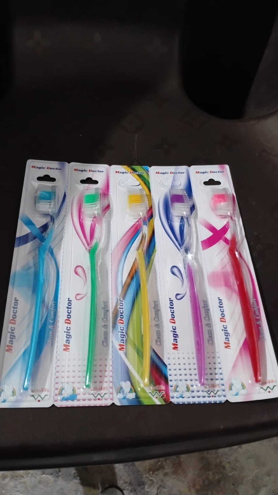 Ergonomic handle of a plastic toothbrush designed for comfortable grip for all ages.