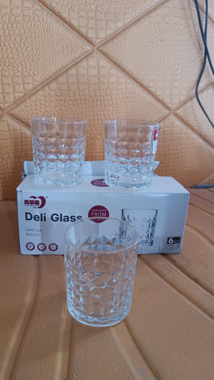 A lifestyle shot of the elegant glass tumbler set on a table with a natural background.