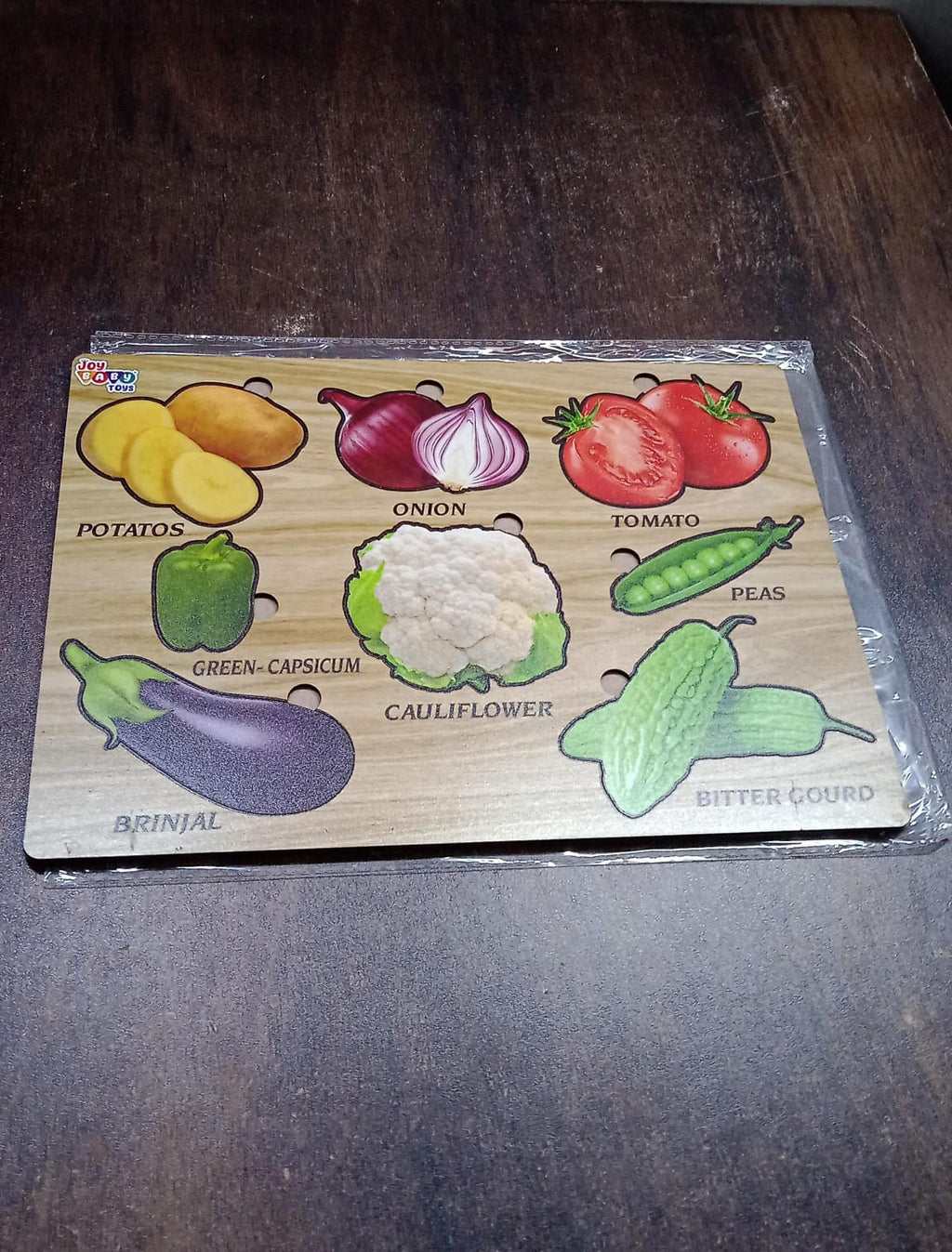 Close-up of smooth, chunky wooden vegetable puzzle pieces, safe for little hands.
