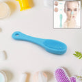 A hand holds the VelvaBloom silicone finger scrubber for gentle facial cleansing.