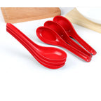 Unbreakable soup spoons in a vibrant red color, set of 6, for dining.