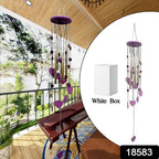 Close-up of the charming smiley and heart design on the decorative wind chime.