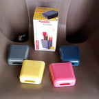 A white wall mounted storage case with a mobile phone and charging cable inserted.