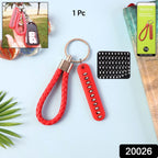 Close-up of anti-lost keychain with unique number plate and braided strap