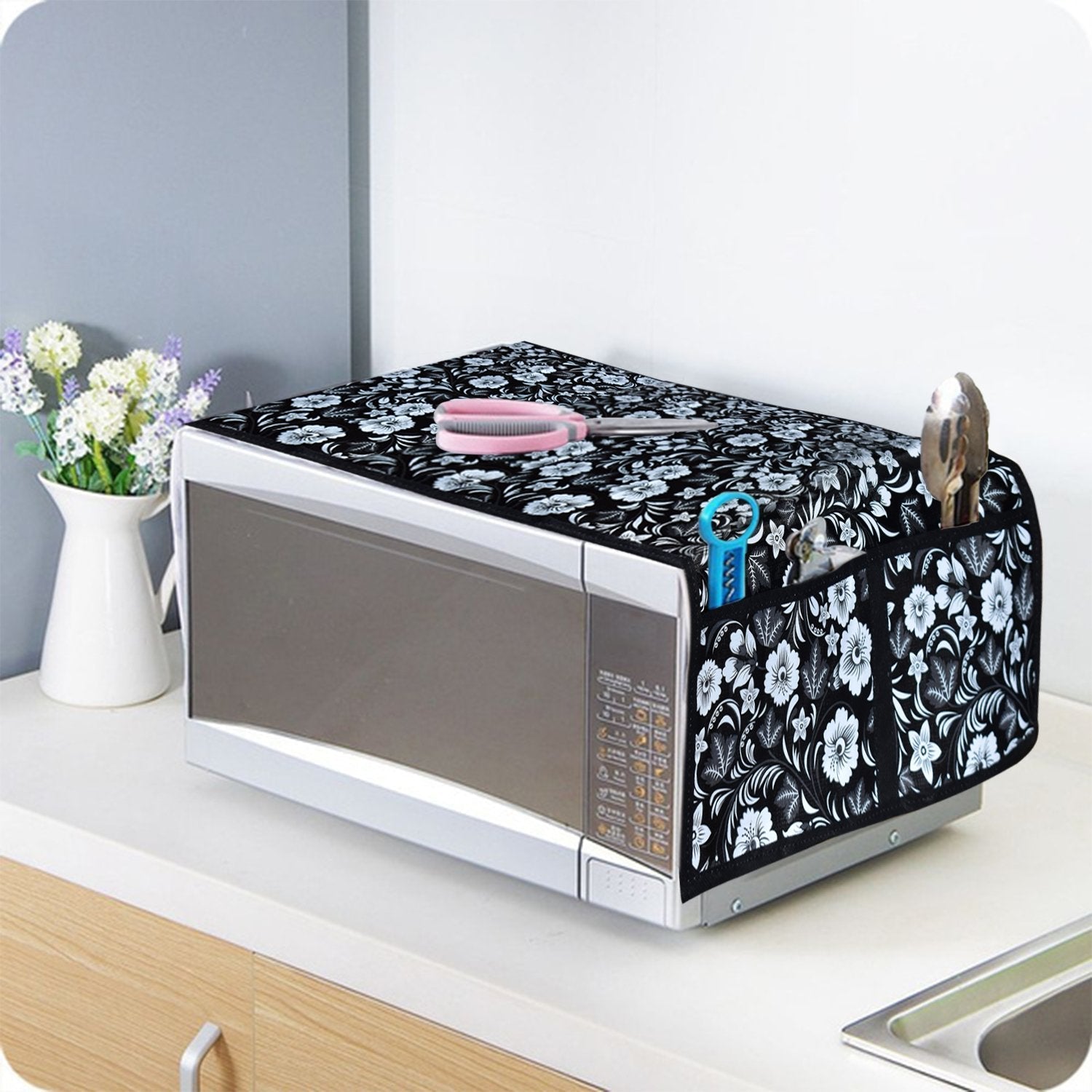 Stylish microwave oven cover with utility pockets in a modern kitchen setting.