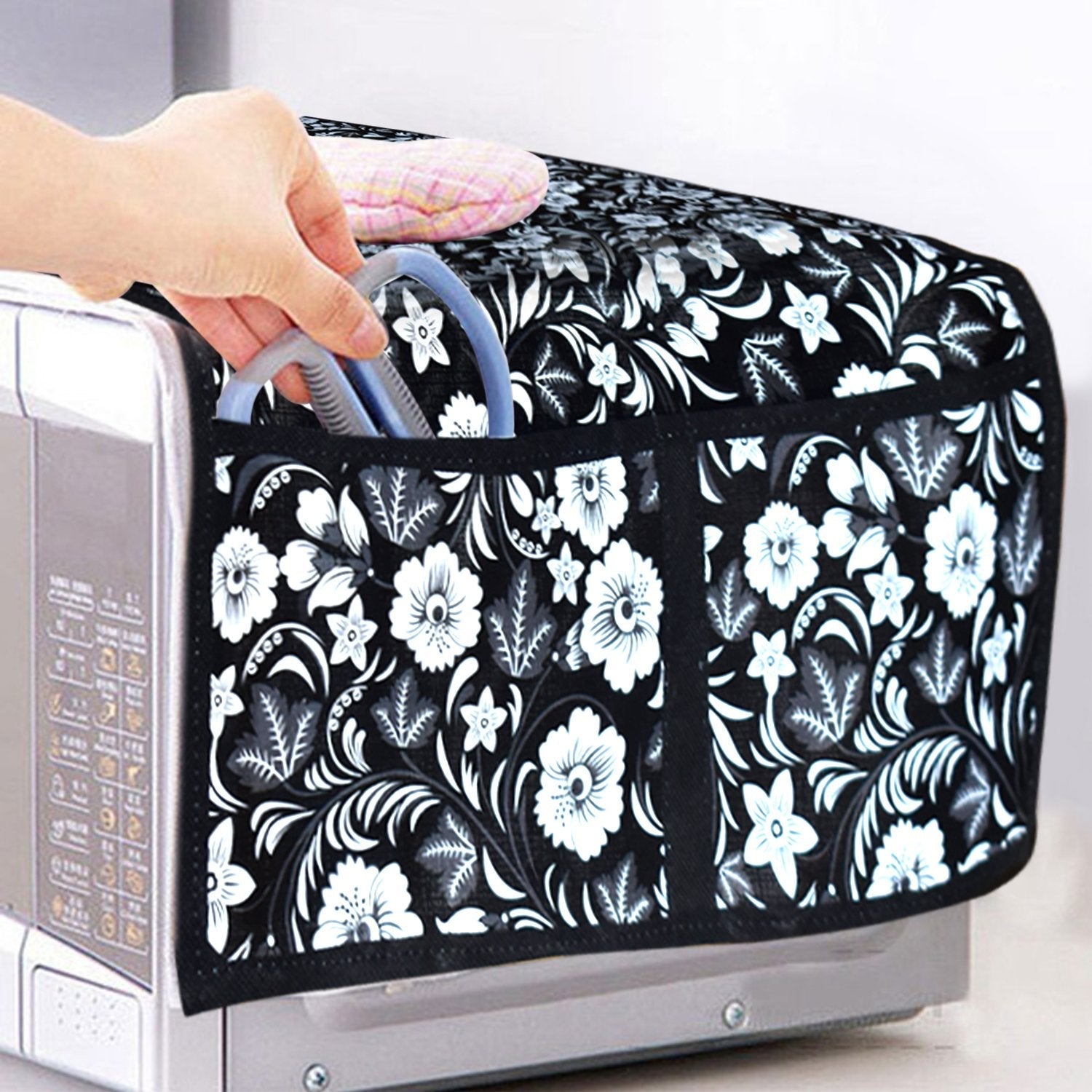 Detailed view of the four practical utility pockets on the side of the oven cover.