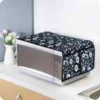 Folded cotton linen microwave cover displayed neatly on a kitchen counter.