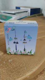 Decorative metal evil eye wind chime displayed as home and garden decor