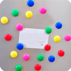 Set of colourful plastic board magnets, ready for use.