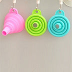 Red silicone funnel with a hanging hole, perfect for easy kitchen storage.