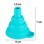 Red silicone funnel pouring juice into a glass bottle on a kitchen counter.