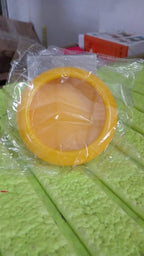 Top-down view of a compact yellow produce saver container.