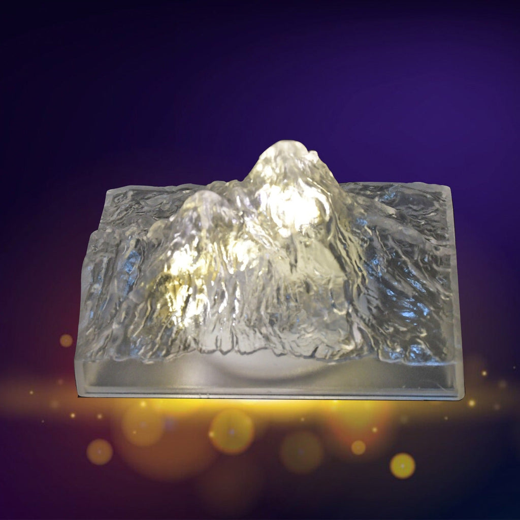 A hand demonstrating the simple one-touch control of the Iceberg Night Light.