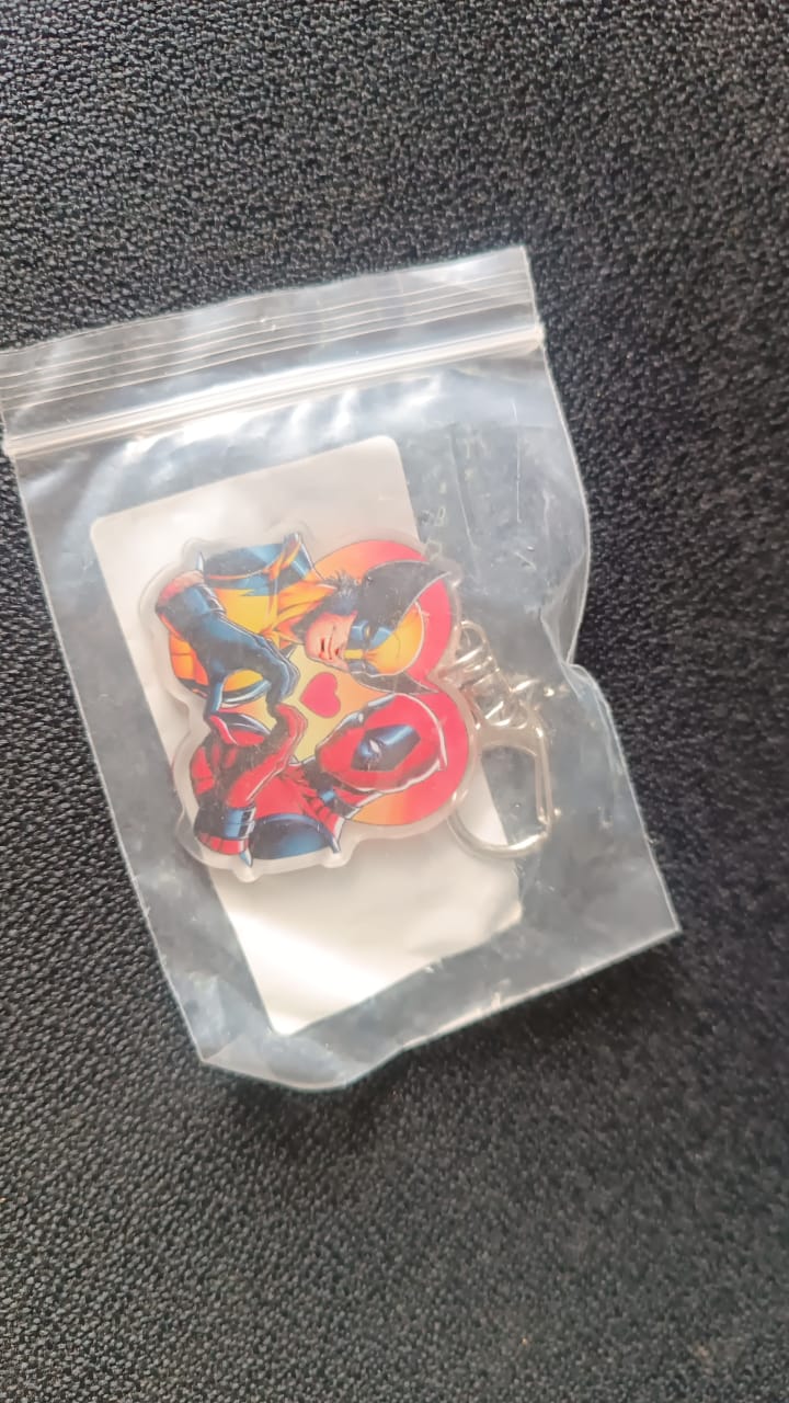 Colorful acrylic keychain featuring cartoon design with metal hardware for easy clipping