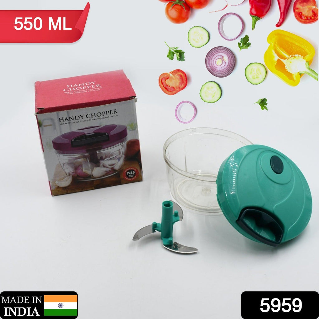 Mini vegetable chopper in action, filled with mixed chopped vegetables.