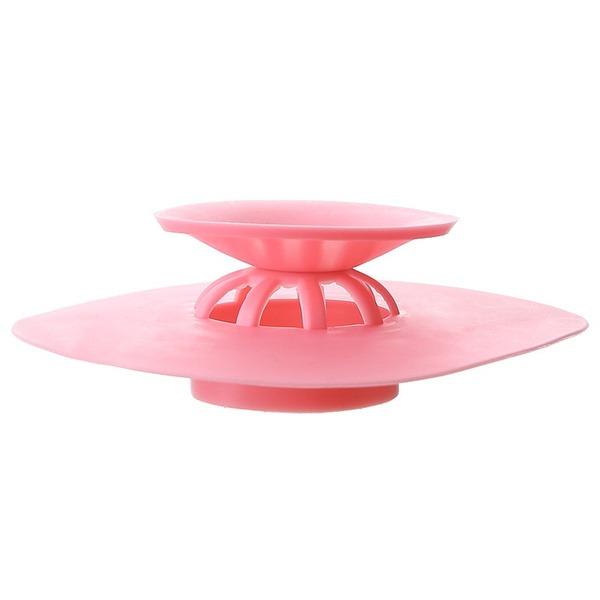 Silicone drainer cover placed on kitchen sink for clog prevention