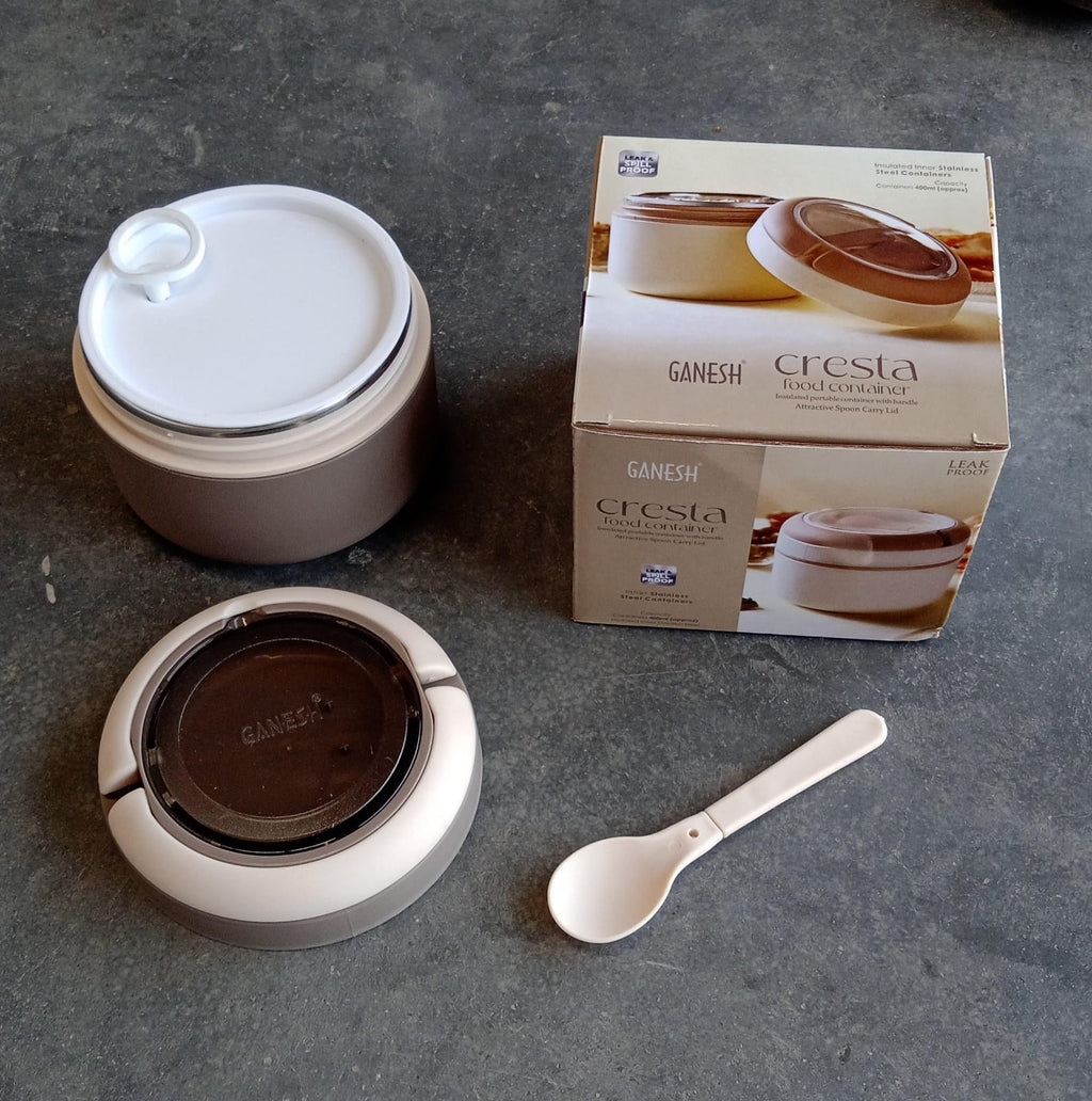 A person enjoying a meal from the insulated food container, perfect for office or school.