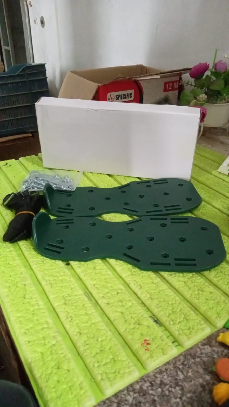 Gardener using the Lawn Aerator Sandals to improve soil health and promote lush grass growth.