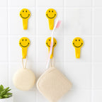 Waterproof self adhesive hooks holding towels in a modern bathroom.