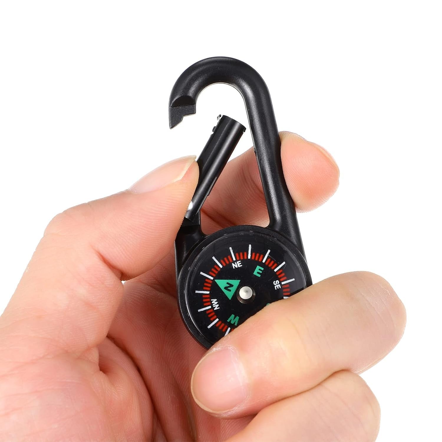 A hand attaching the mini compass with clip to a belt loop, emphasizing its convenient attachment.