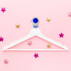 Colorful plastic ball-shaped wall hook holding bathroom towel