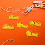 A single self adhesive hook securely holding a bunch of keys on a wall.