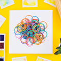 Vibrant multicolor rubber bands bundled together for office organization.