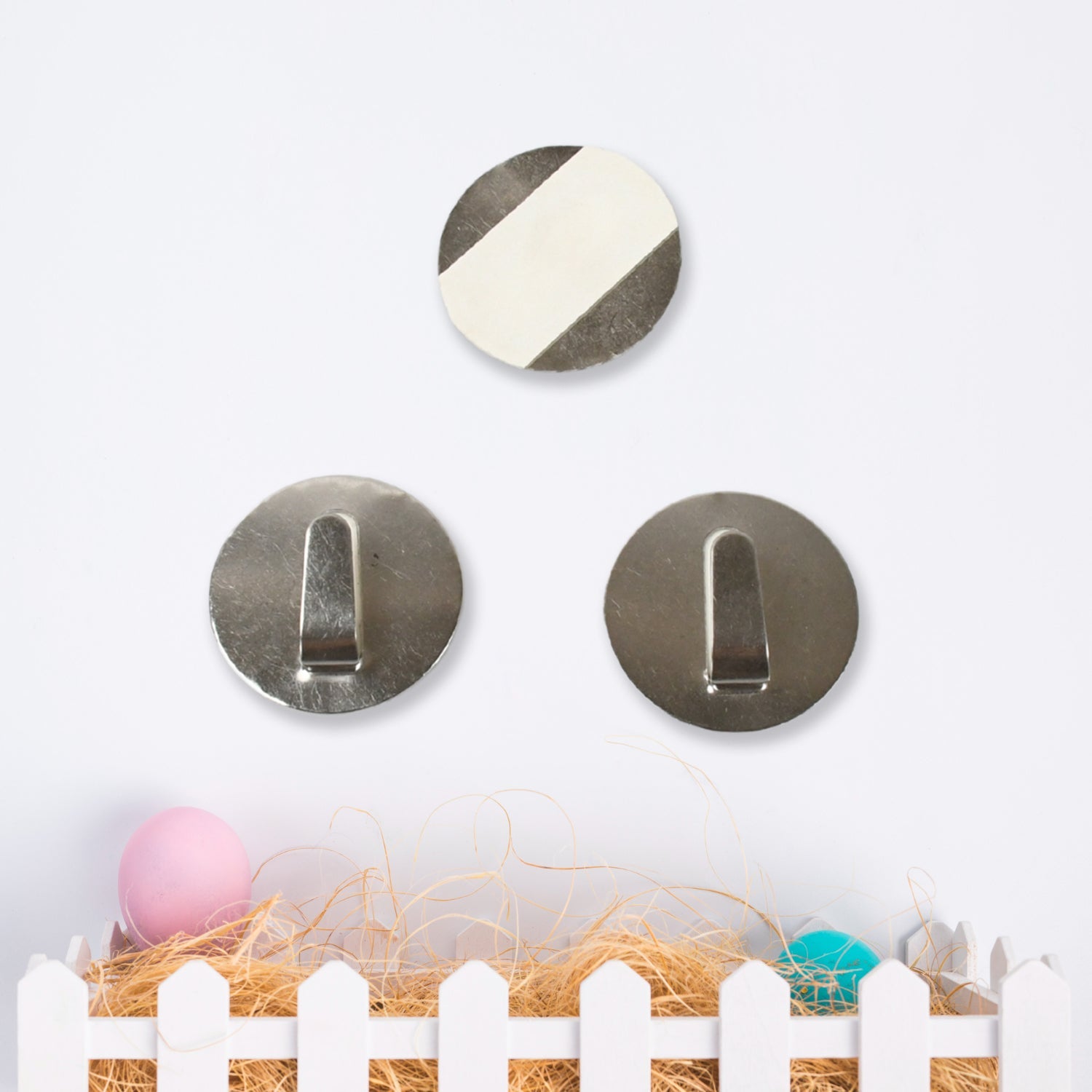 Self-adhesive hooks securely holding kitchen utensils like a spatula and whisk.