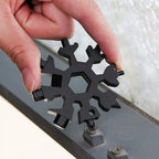 Side profile of the durable stainless steel Snowflake Multi-Tool, emphasizing its slim form.