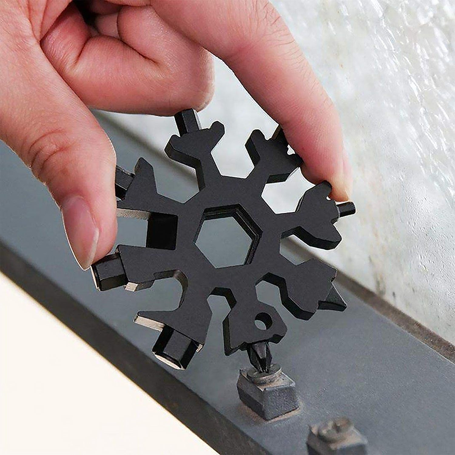 Side profile of the durable stainless steel Snowflake Multi-Tool, emphasizing its slim form.