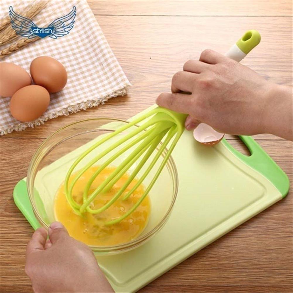 Comfortable handheld plastic whisk, perfect for whipping eggs and stirring coffee.