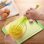 Comfortable handheld plastic whisk, perfect for whipping eggs and stirring coffee.