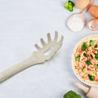 A hand holding the heat-resistant pasta fork, demonstrating its ergonomic design and ease of use.