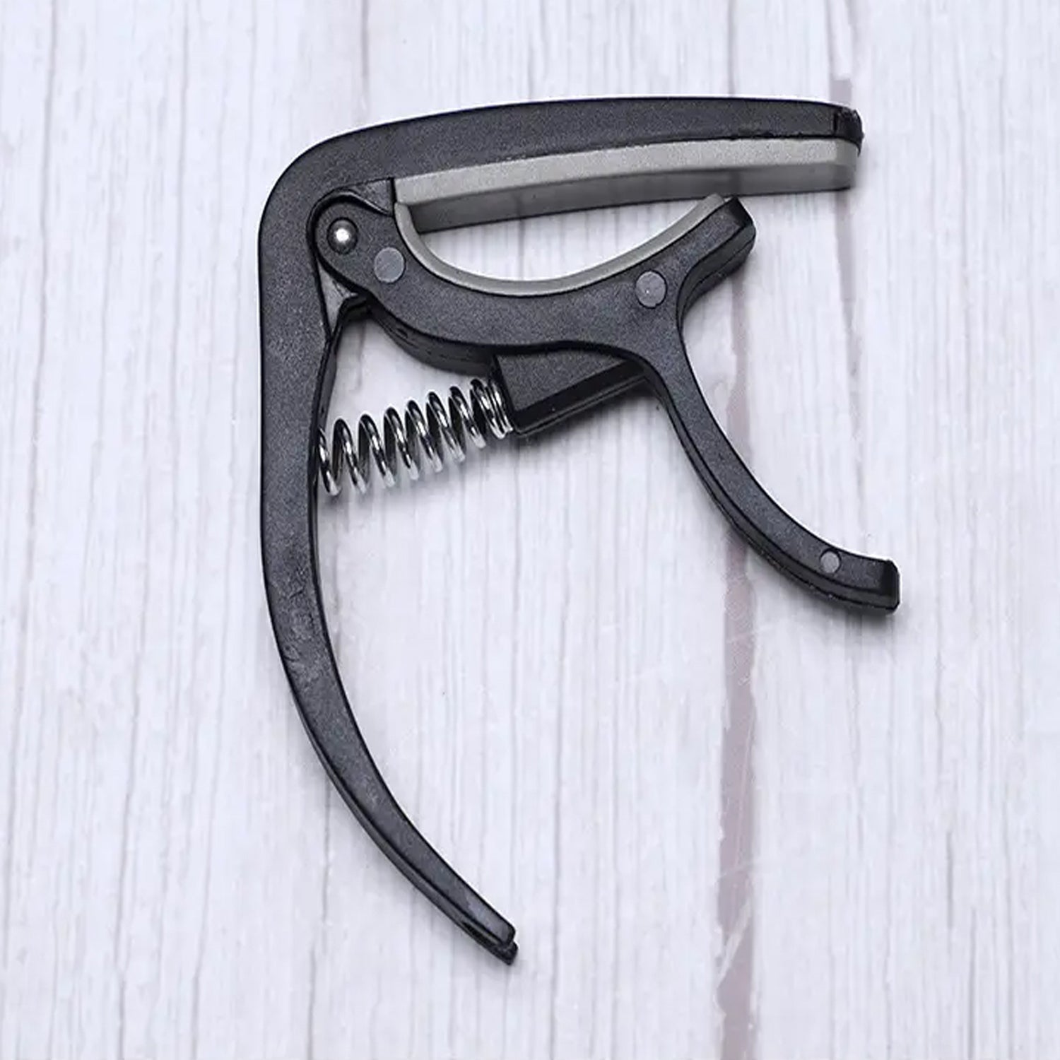 Detail of the Wagtail guitar capo's protective soft pad, preventing instrument damage.