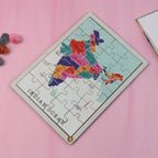 Child's hands actively placing a state piece on the India map puzzle, fostering learning.