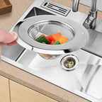 A shiny stainless steel sink strainer installed in a kitchen basin, preventing food waste.