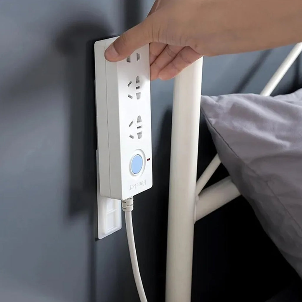 The compact Self Adhesive Plug Organizer fixing various cables behind a TV unit for a tidy look.