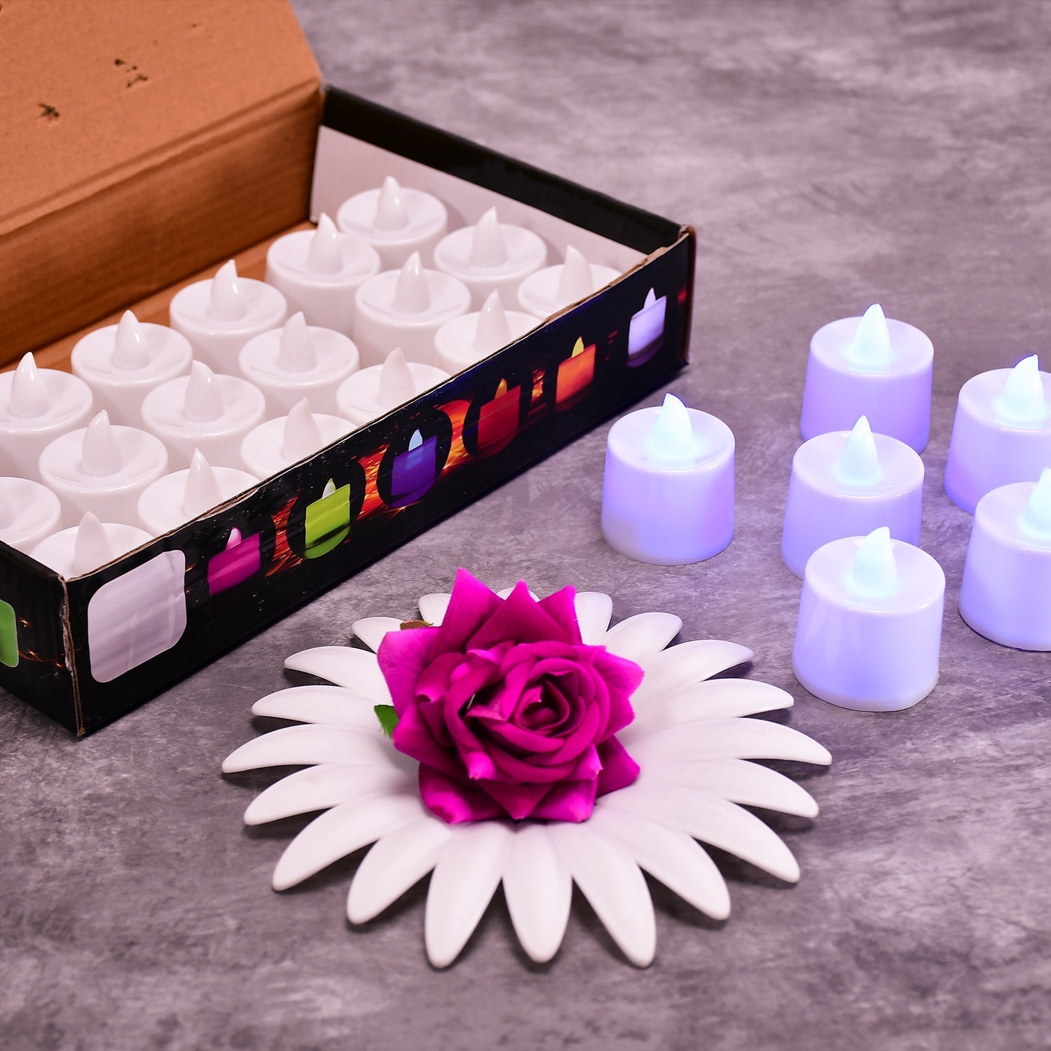Pink flameless LED tealights glowing softly in a cluster.