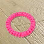 A bulk pack of 100 multi-colored telephone wire hair bands.