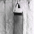 Back view of the waste bag holder, showing the wide handle for easy hanging on a hook.